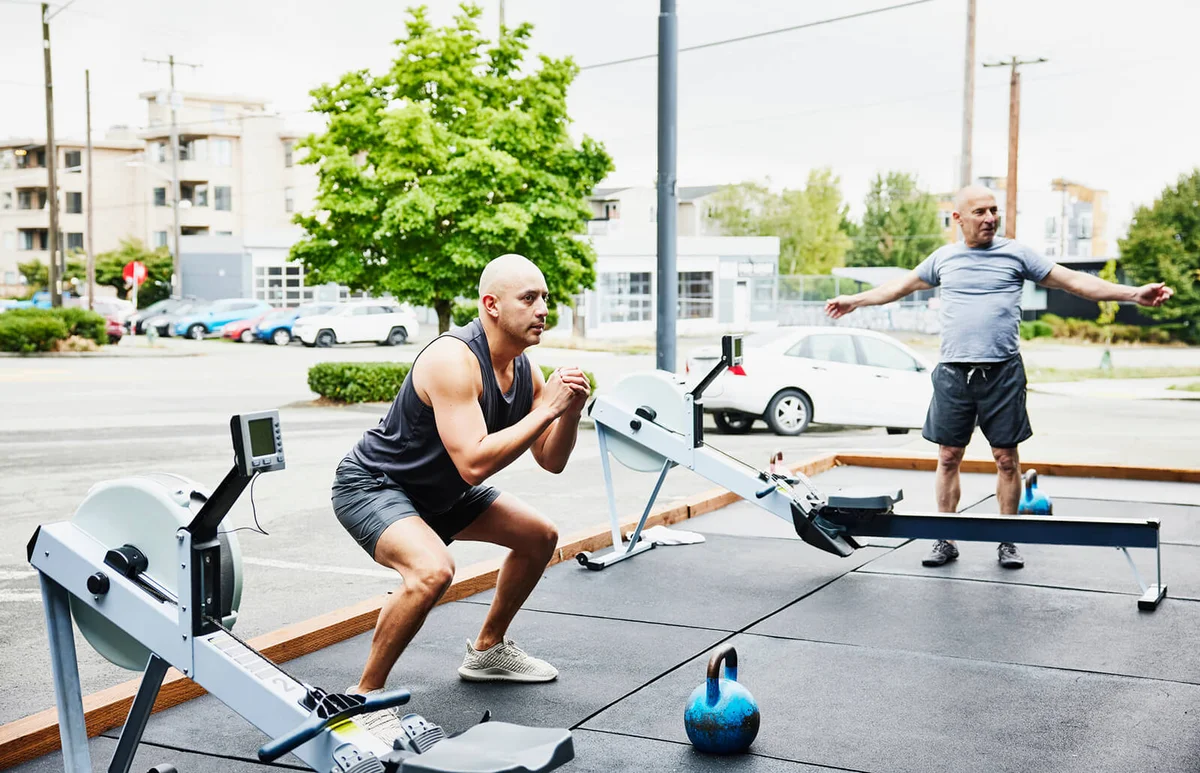 Men warming up before workout at outdoor gym