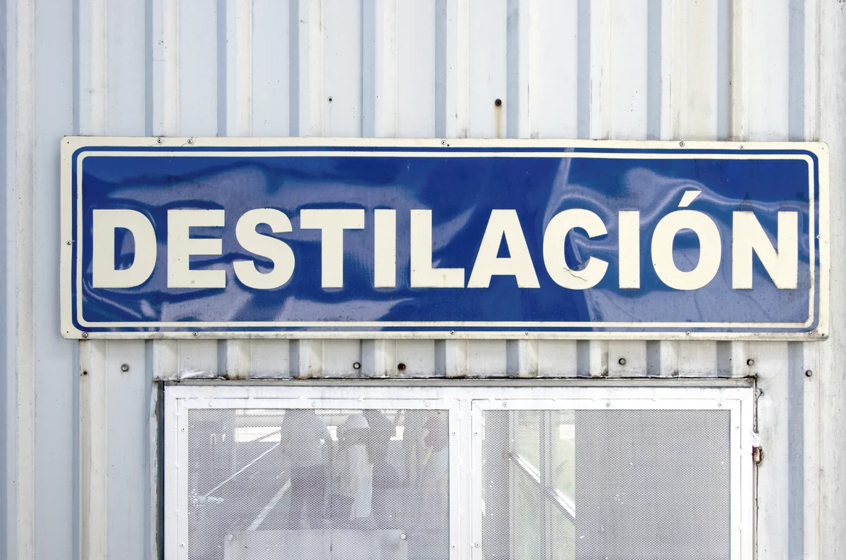 Spanish-language sign stating 'Destilación' [Distillation] on the outside of a tequila factory