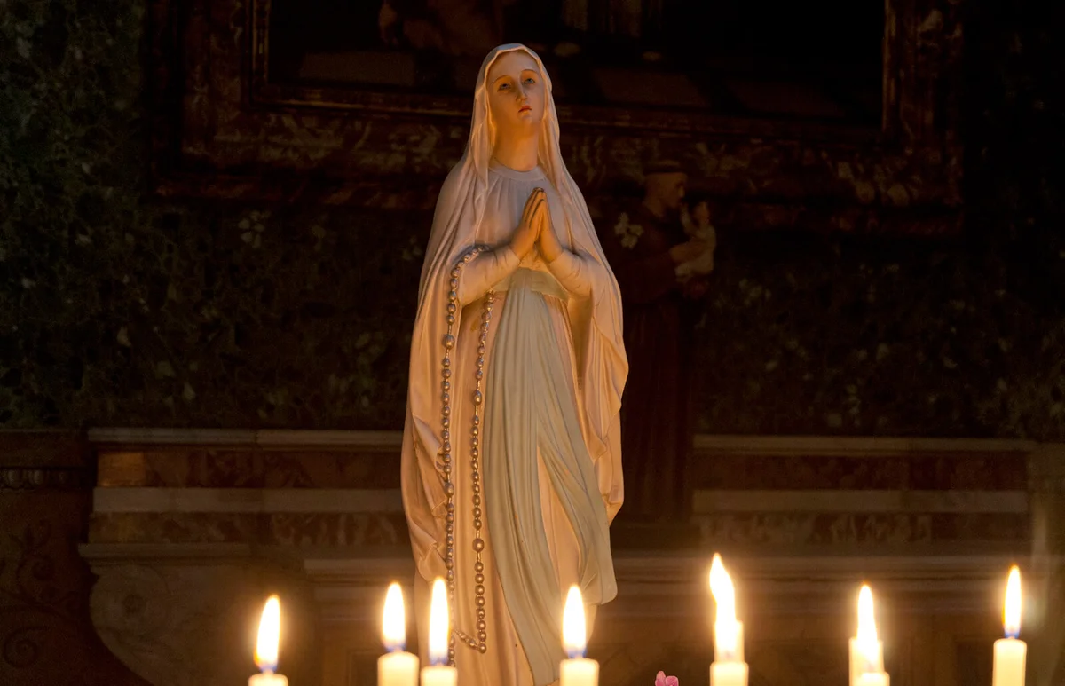 Virgin Mary and candles in cathedral
