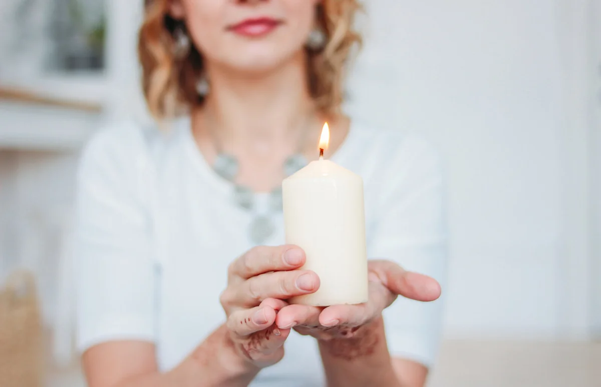 Woman Holding Burning Candle