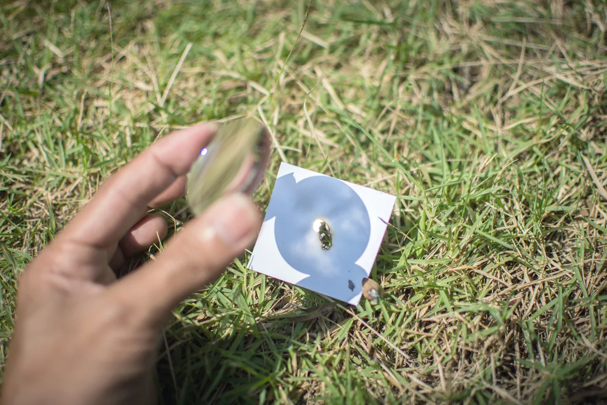 Merge sunlight with paper with a convex lens