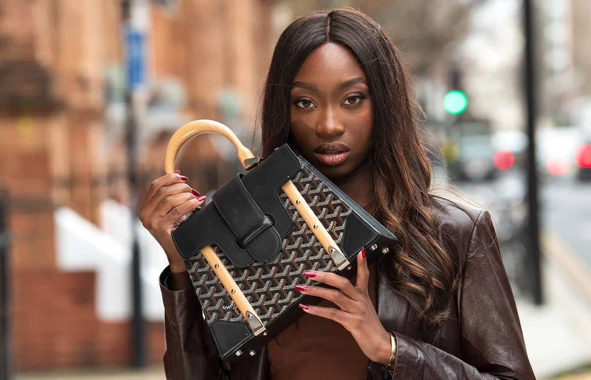 Model and Digital influencer Lauren Lemboumba wears a Reformation top, Joseph coat and a Goyard bag on January 08, 2021 in London, England | Getty Editorial Use