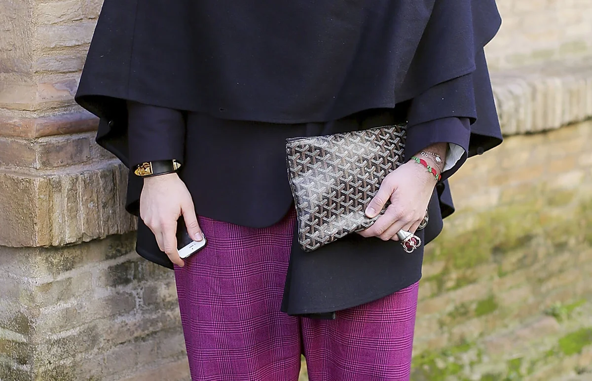 Designer Marco Ferra wears Goyard bag, Hermes coat and cape on day 2 Rome Fashion Week Spring/Summer 2014, on January 23, 2014 in Paris,in Rome, Italy | Getty Editorial Use