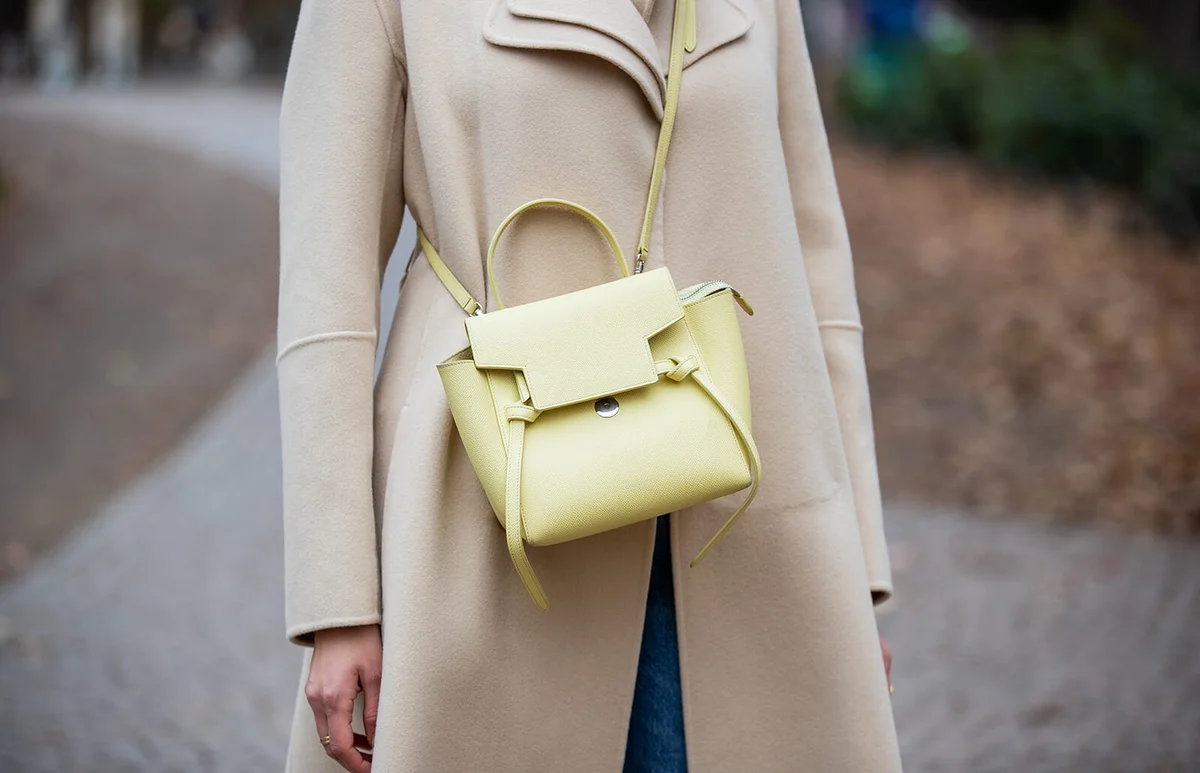 Victoria Scheu is seen wearing Ripped Mom Jeans Zara, brown turtleneck Hallhuber, Cashmere Coat Sportmax, lemon yellow bag by Celine, LA Cap on November 18, 2020 in Frankfurt am Main, Germany. | Getty Editorial Use