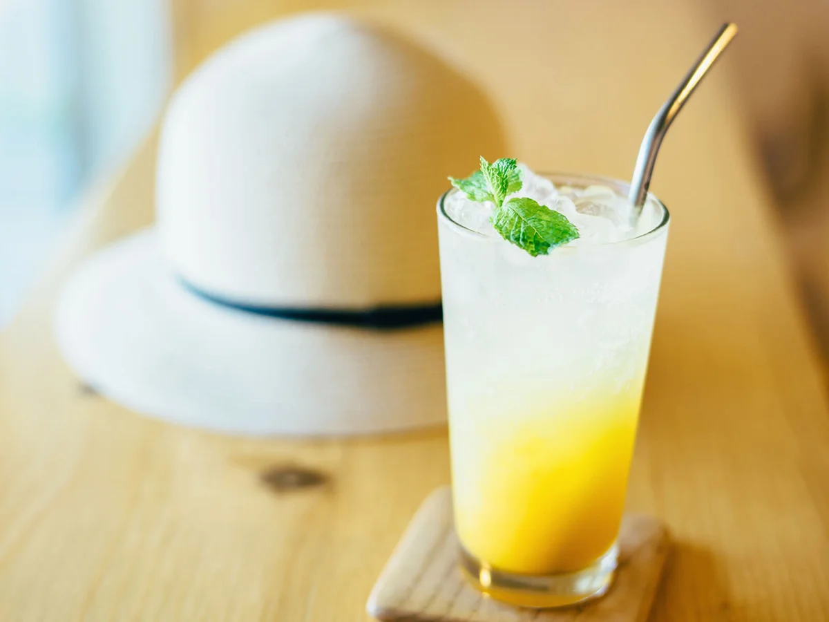 A glass of refreshing iced passion fruit and mango soda served on table in the cafe