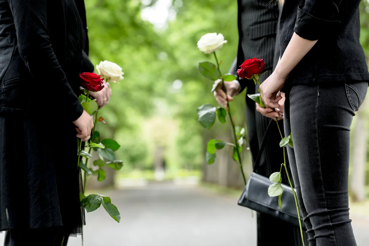 Friends With Roses Standing On Footpath