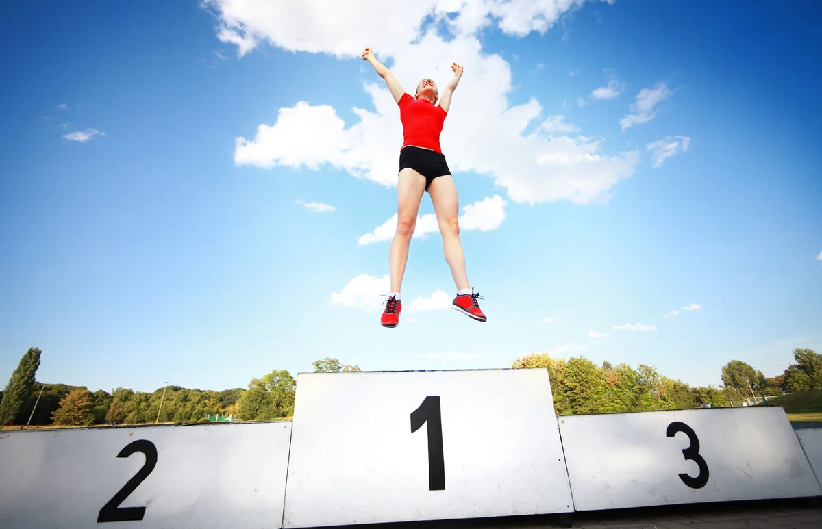 female athlete enjoying victory on a winners podium