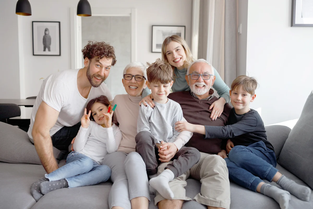 Multi generational family is posing on the couch