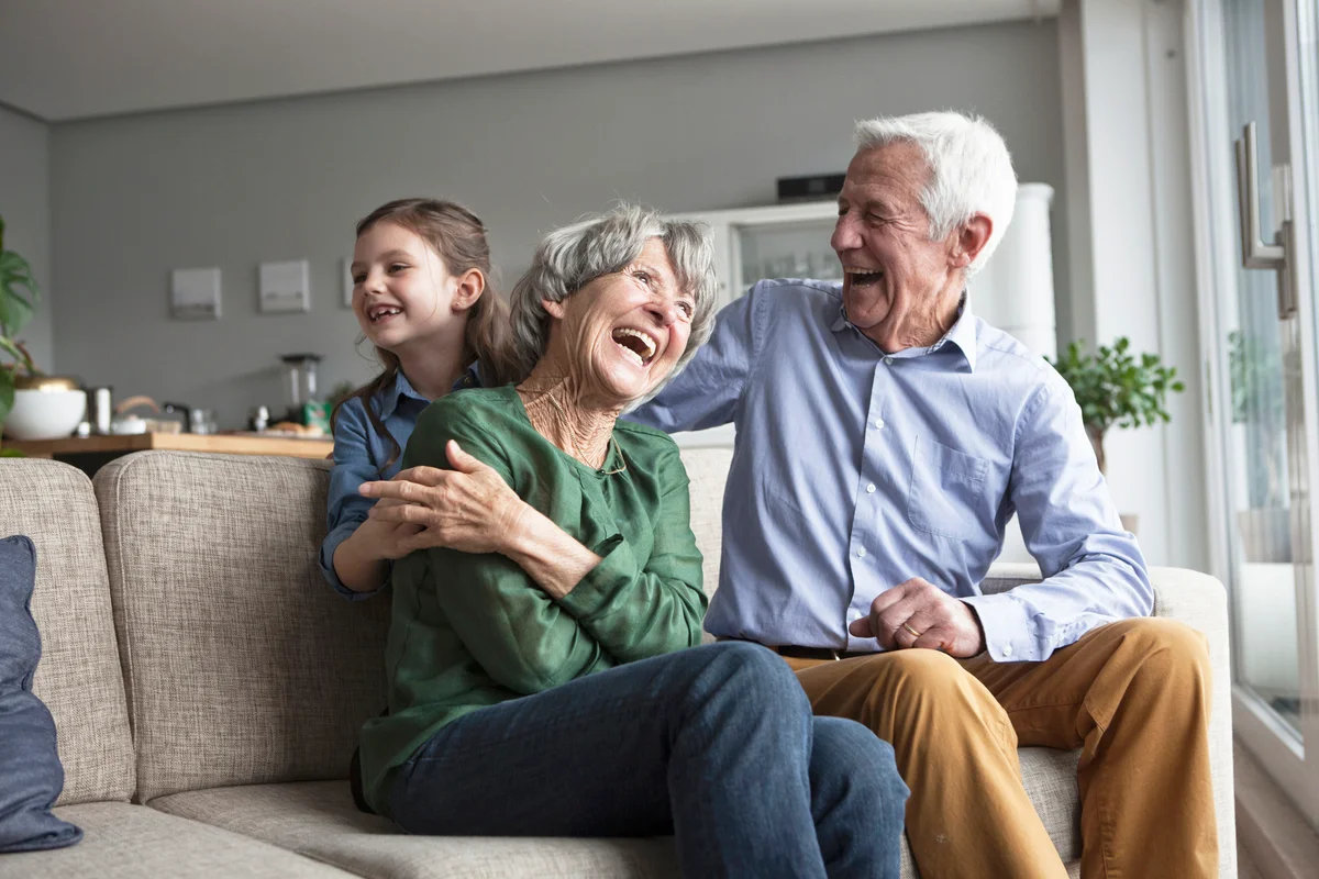Little girl and her grandparents having fun