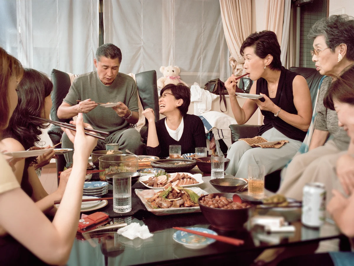 Multi generational family dining in living room
