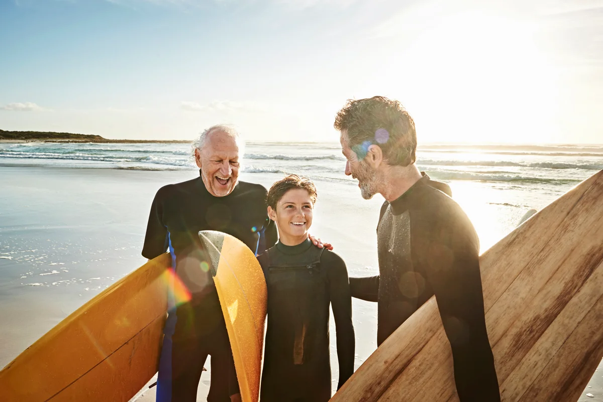 Grandfather, father and son surfing