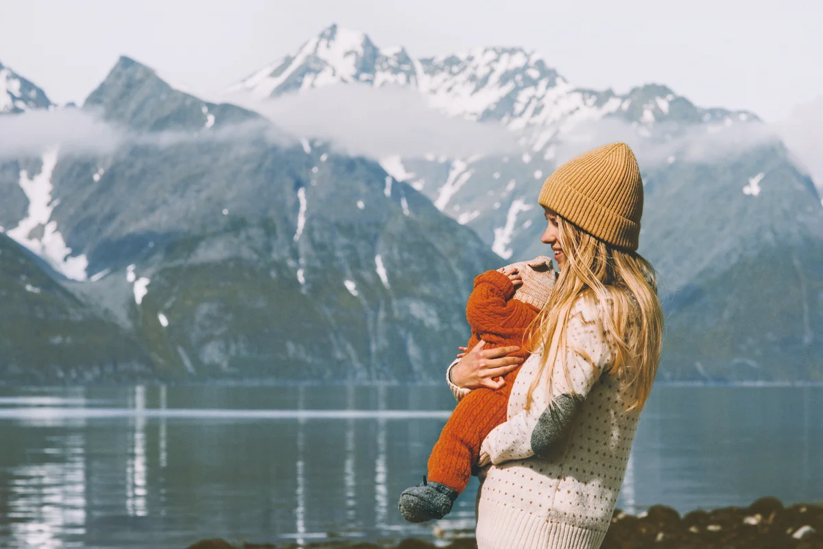 Mother with baby traveling and enjoying mountains view