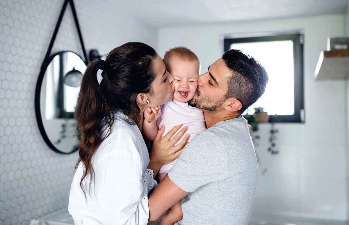couple with toddler girl in the morning indoors in bathroom at home