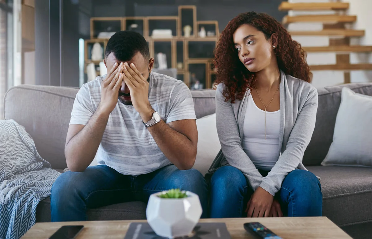 young man looking upset after having an argument with his girlfriend