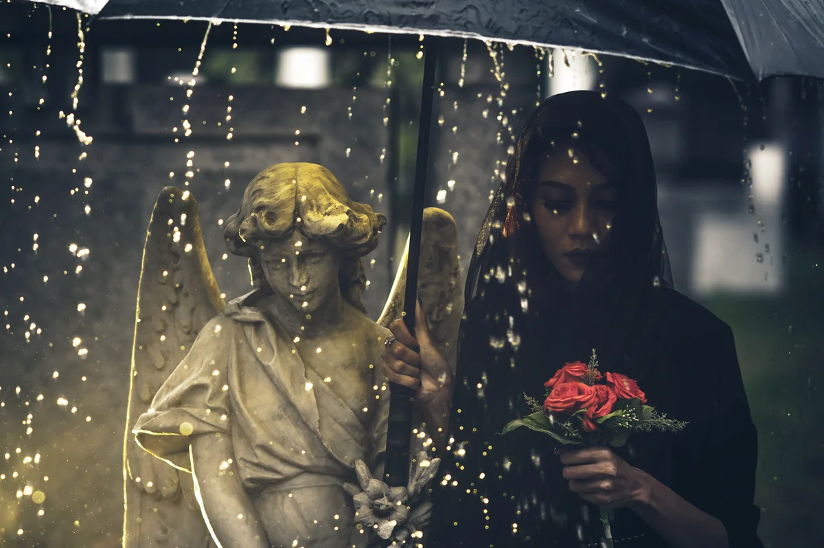 Young Woman Walking By Statue During Rainy Day