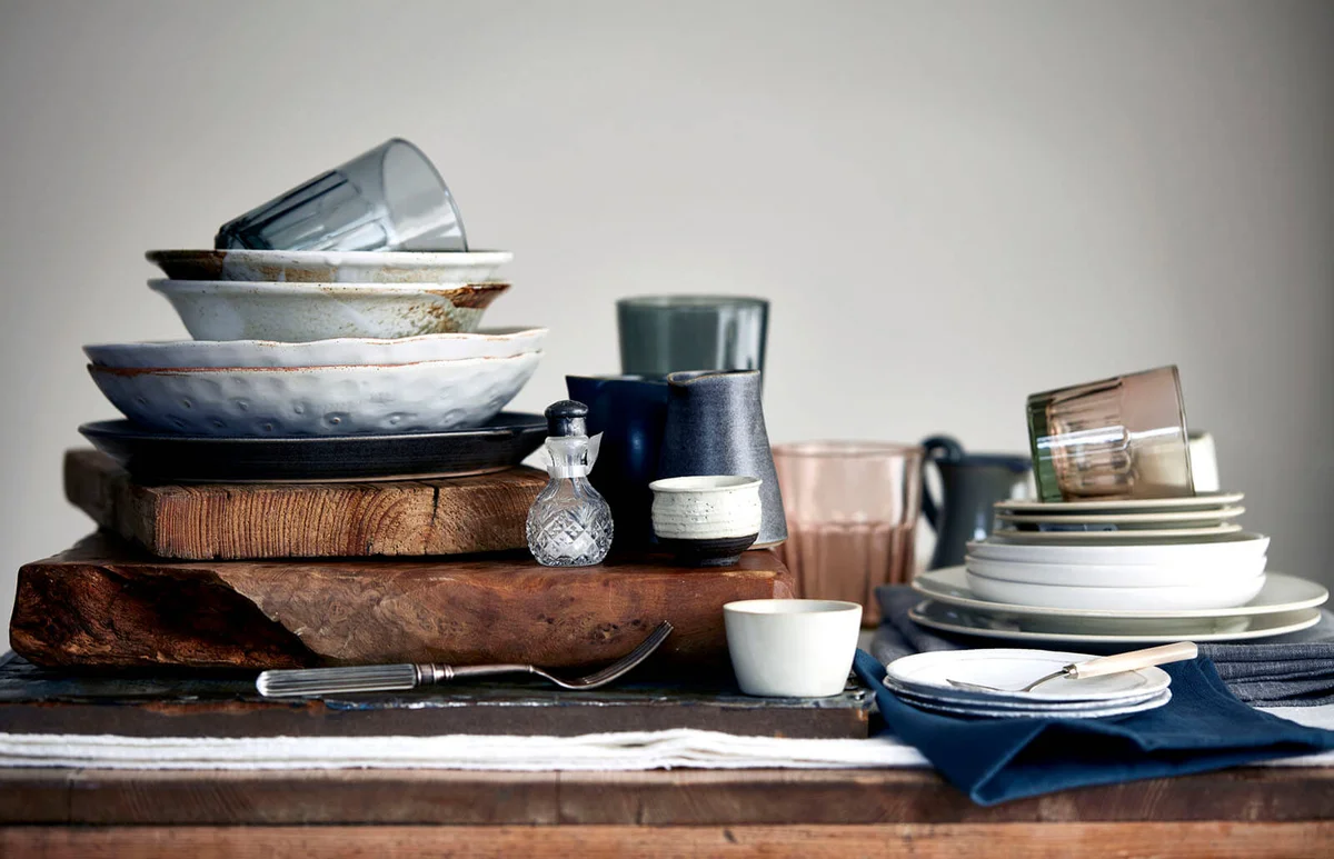 Stacked crockery stacked on cutting board for washing up