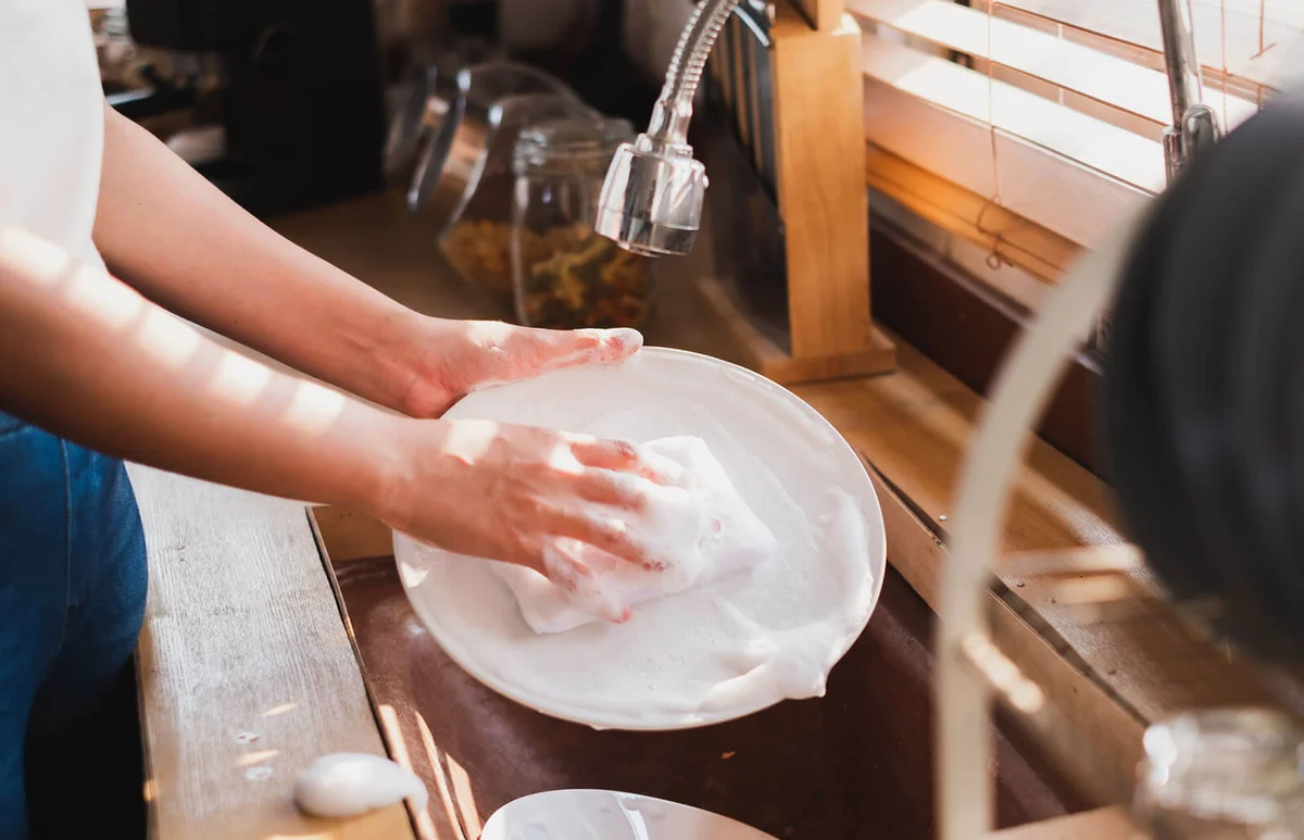 woman washing cleaning dishes in the kitchen
