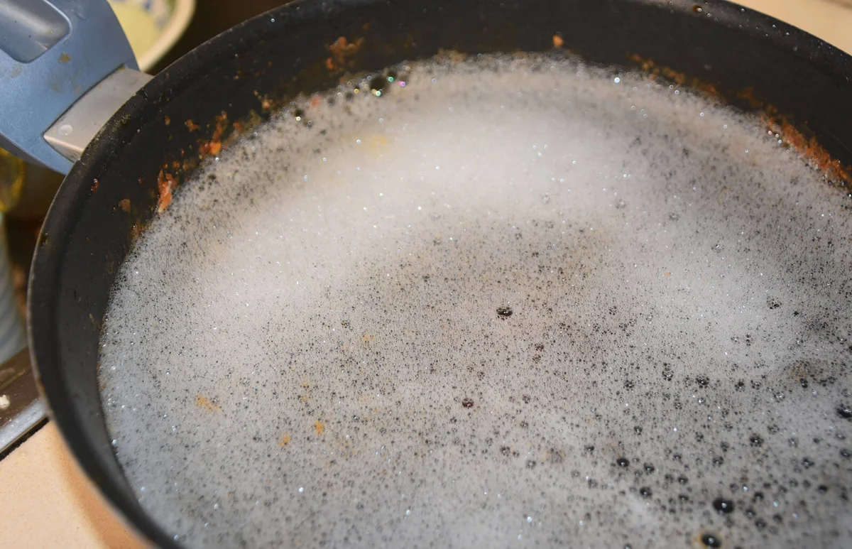 Soaking pot in water and soap