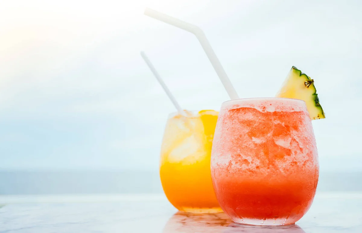 Drinks On Table Against Sea
