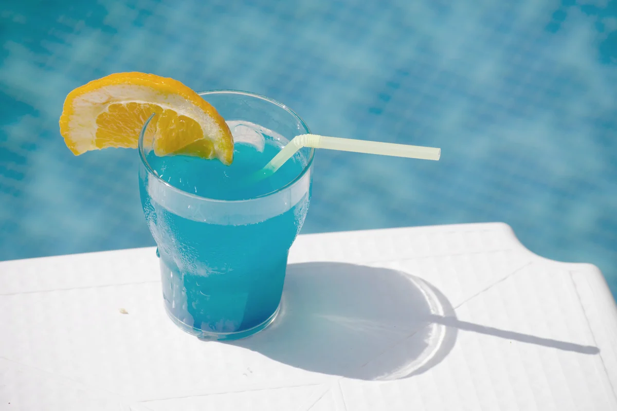 Fresh Cocktail On Table Against Swimming Pool