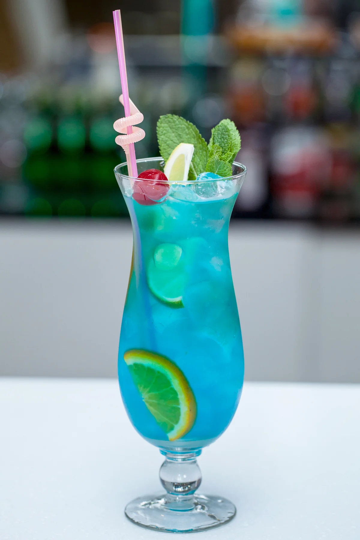 Blue Lagoon cocktail with a slice of lime and mint