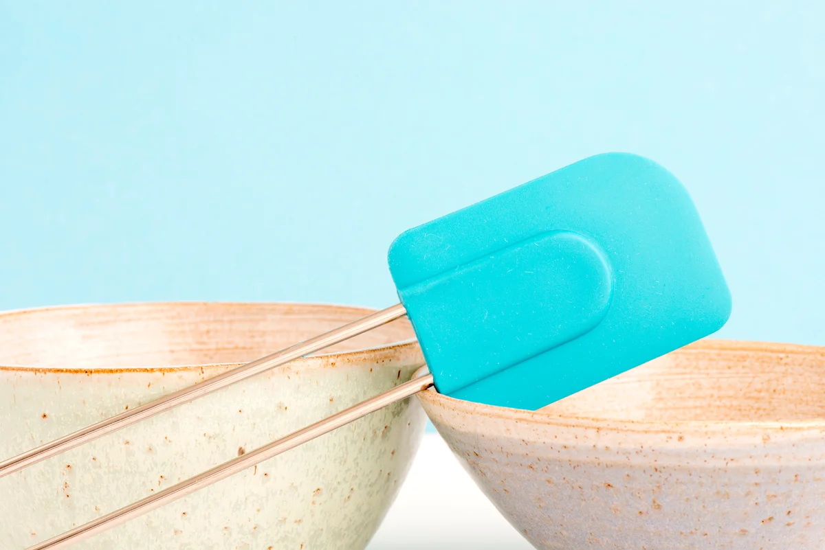 Kitchen bowl and dough scraper on table