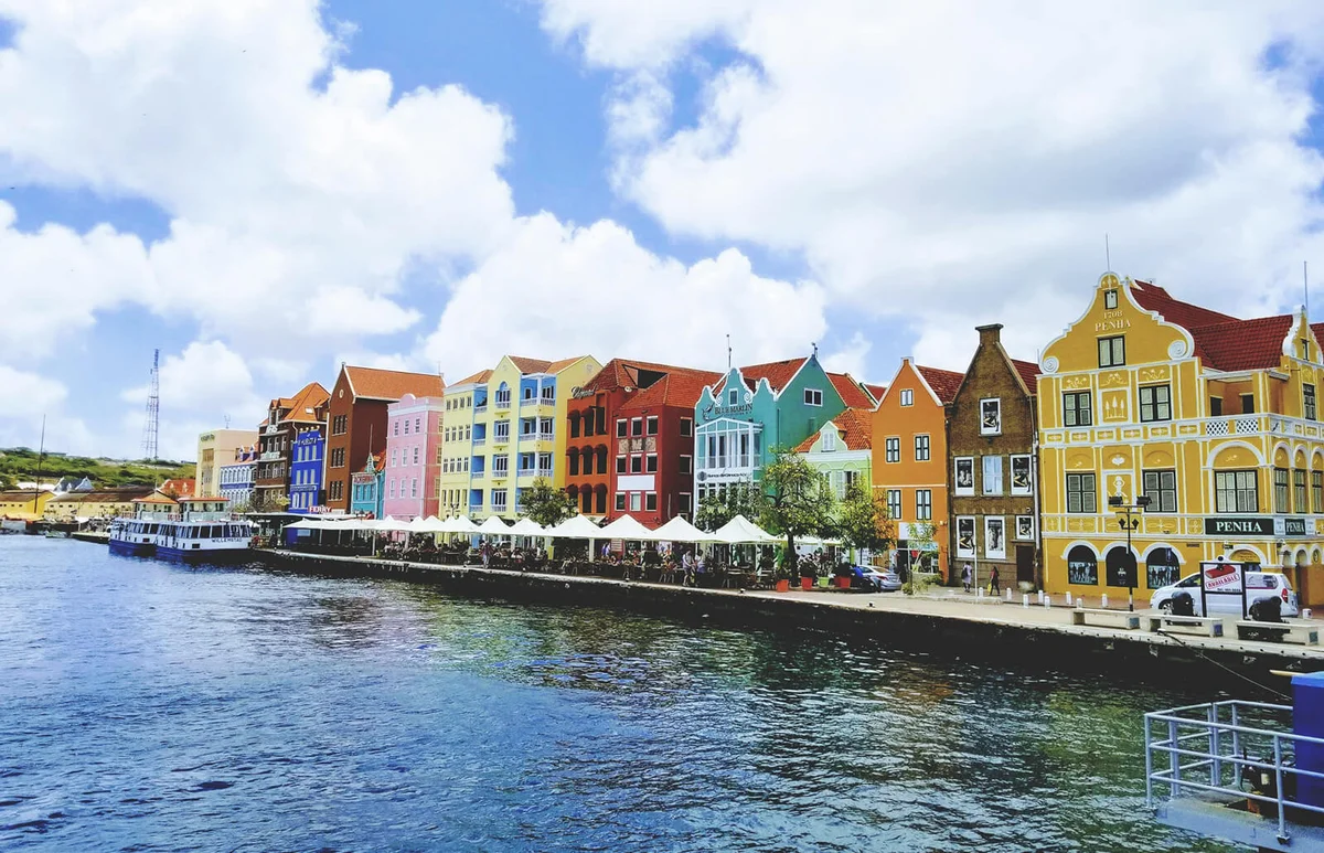 Buildings By River Against Sky In City