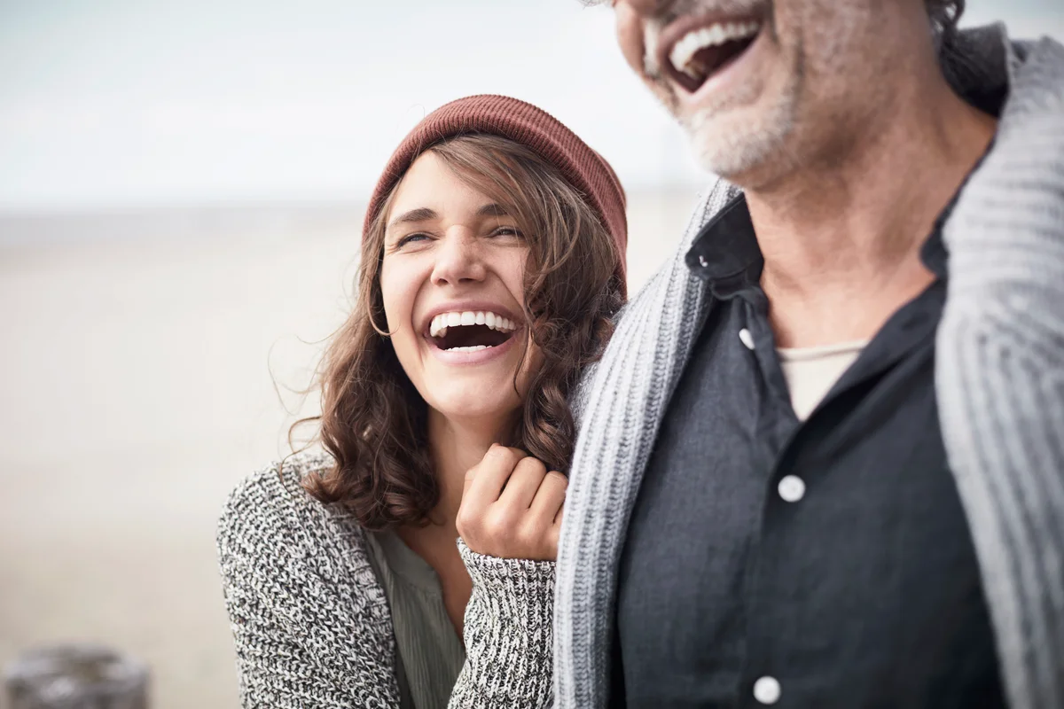 Happy father with adult daughter on the beach