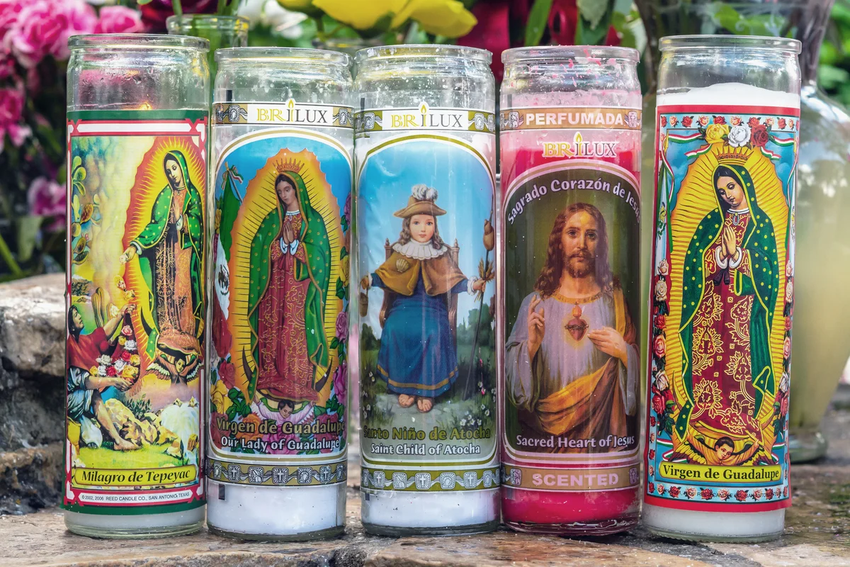 Religious candles offered and placed by devotees at a Catholic shrine