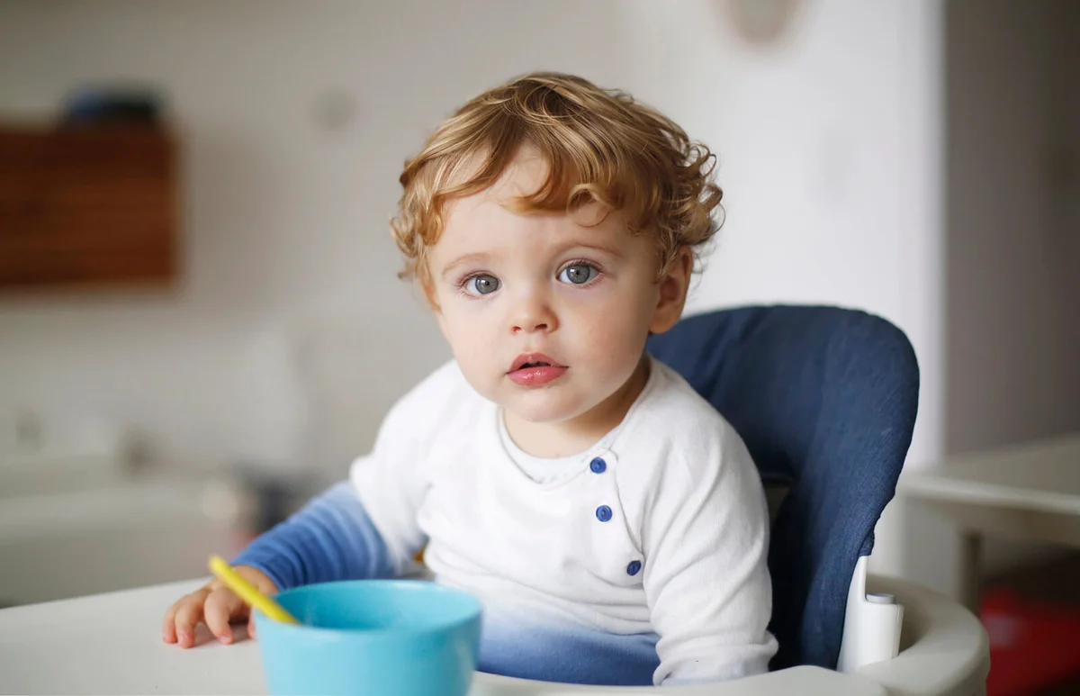 A 15 months old boy in his high chair