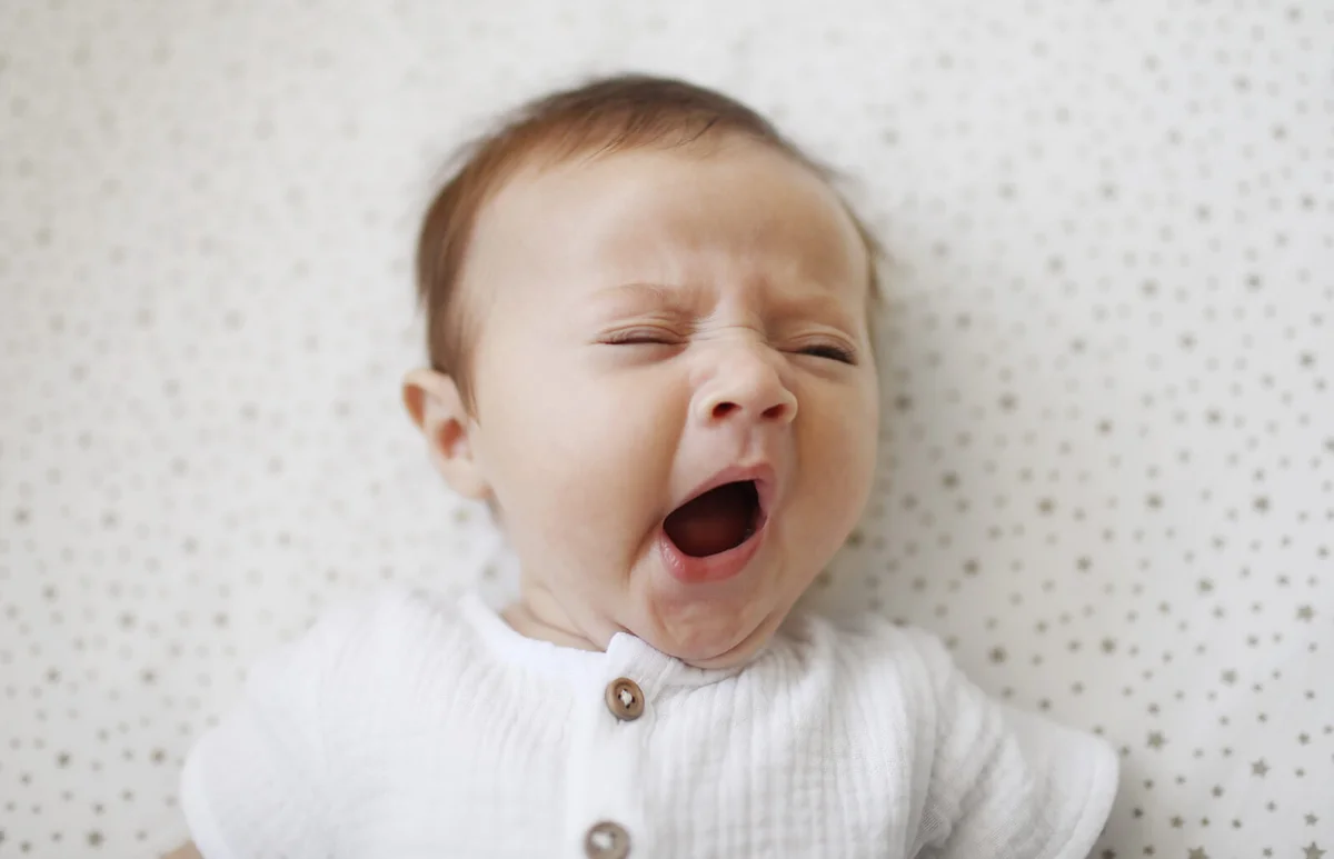 A 4 month old baby girl yawning