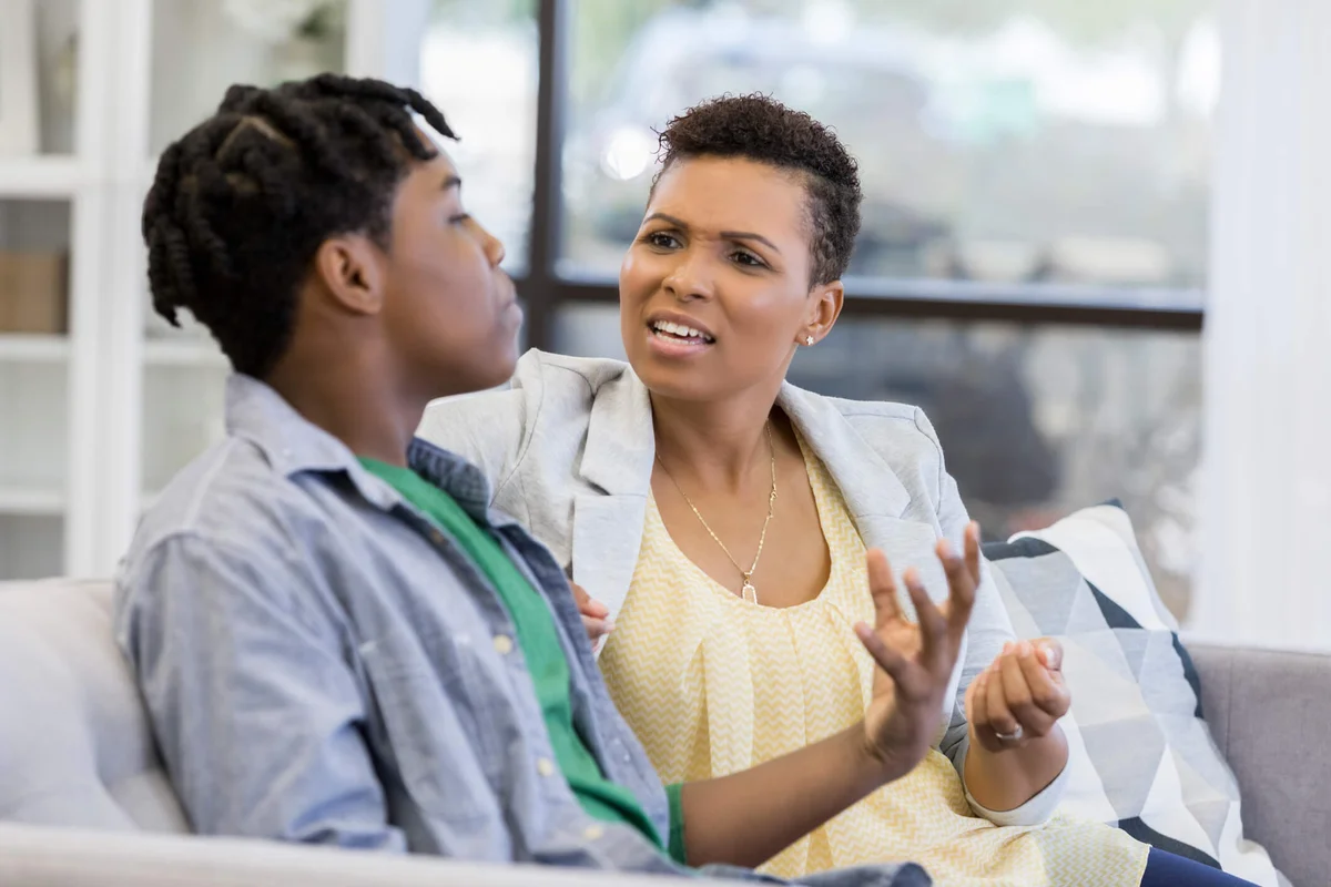 mom and her teenage son argue at home