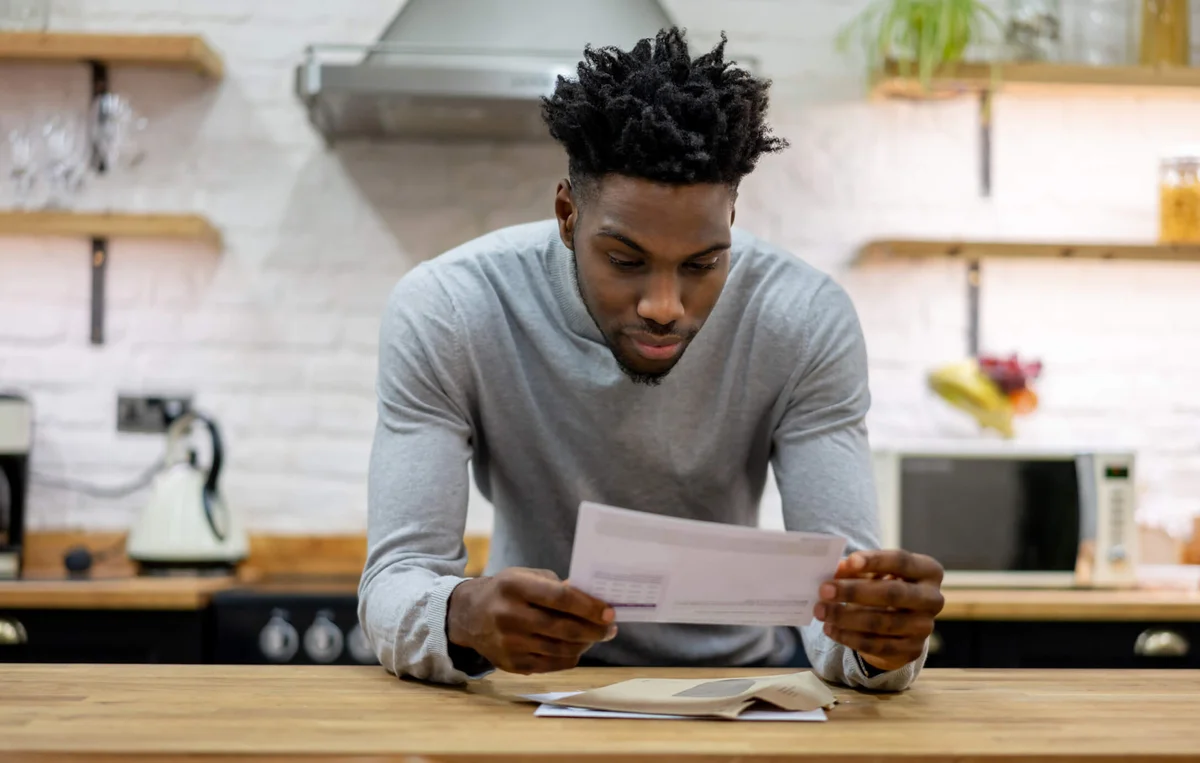 man at home reading the mail