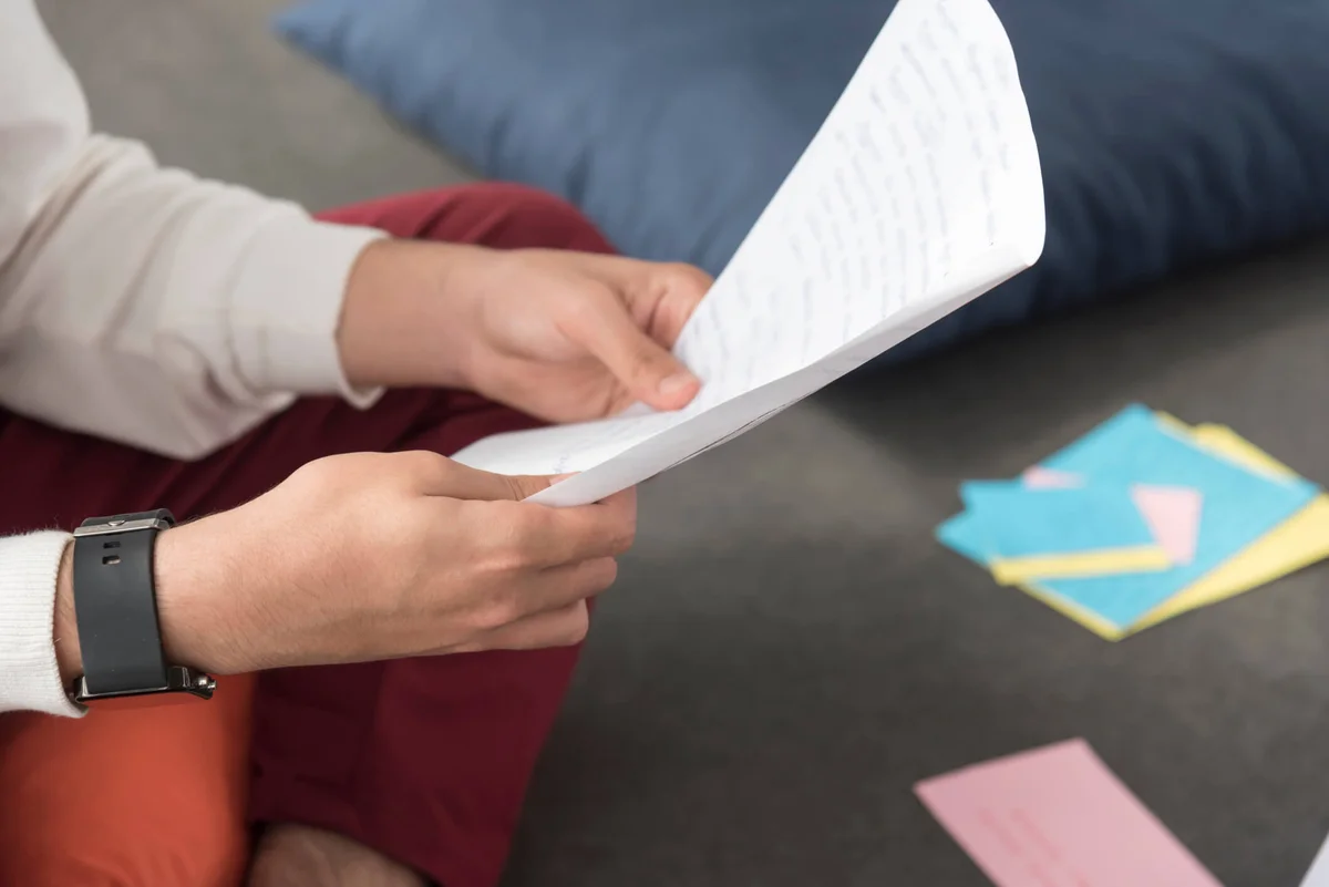 man reading the letter sitting on the floor