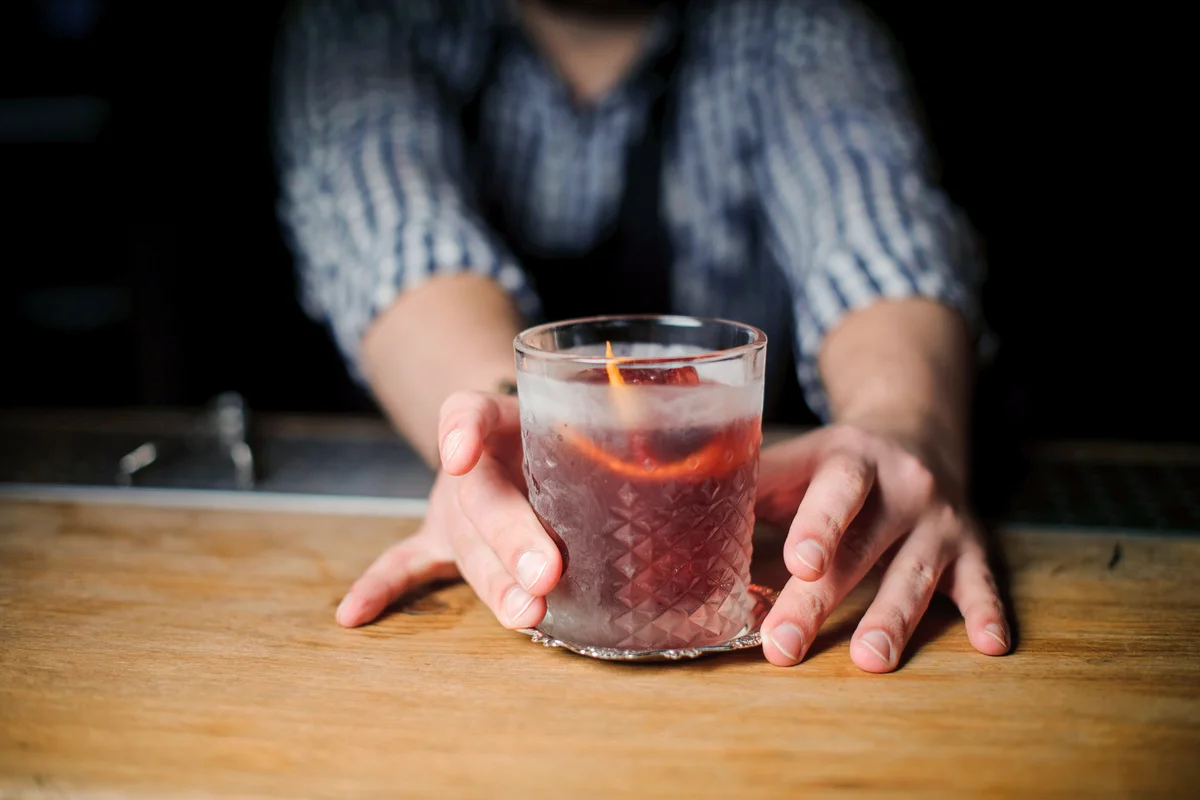 Barman at work, serving cocktails