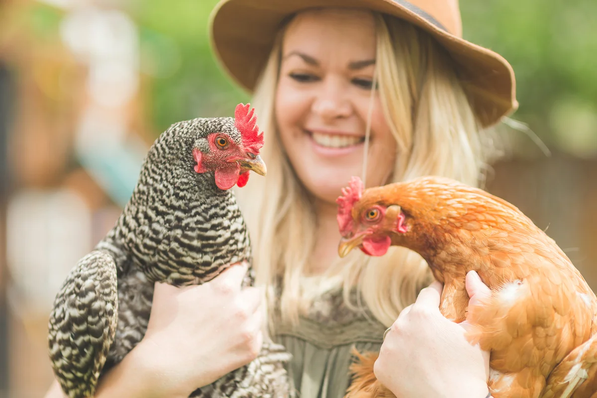 Woman holding two chicken