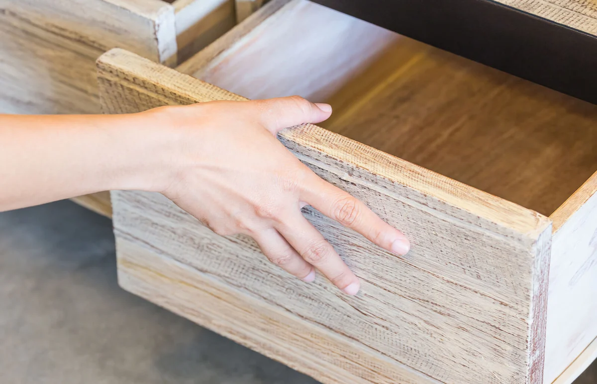 Cropped Hand Of Person Opening Drawer