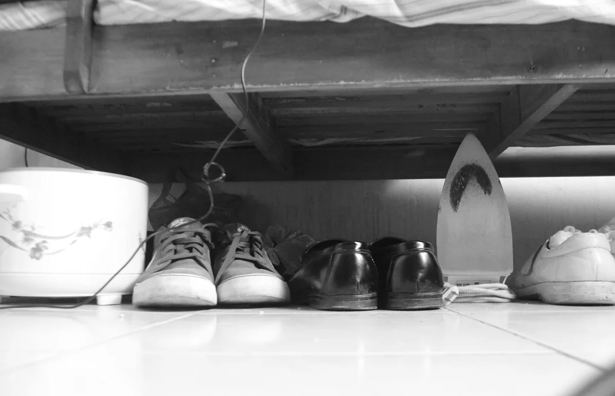Shoes And Iron Under Bed At Home