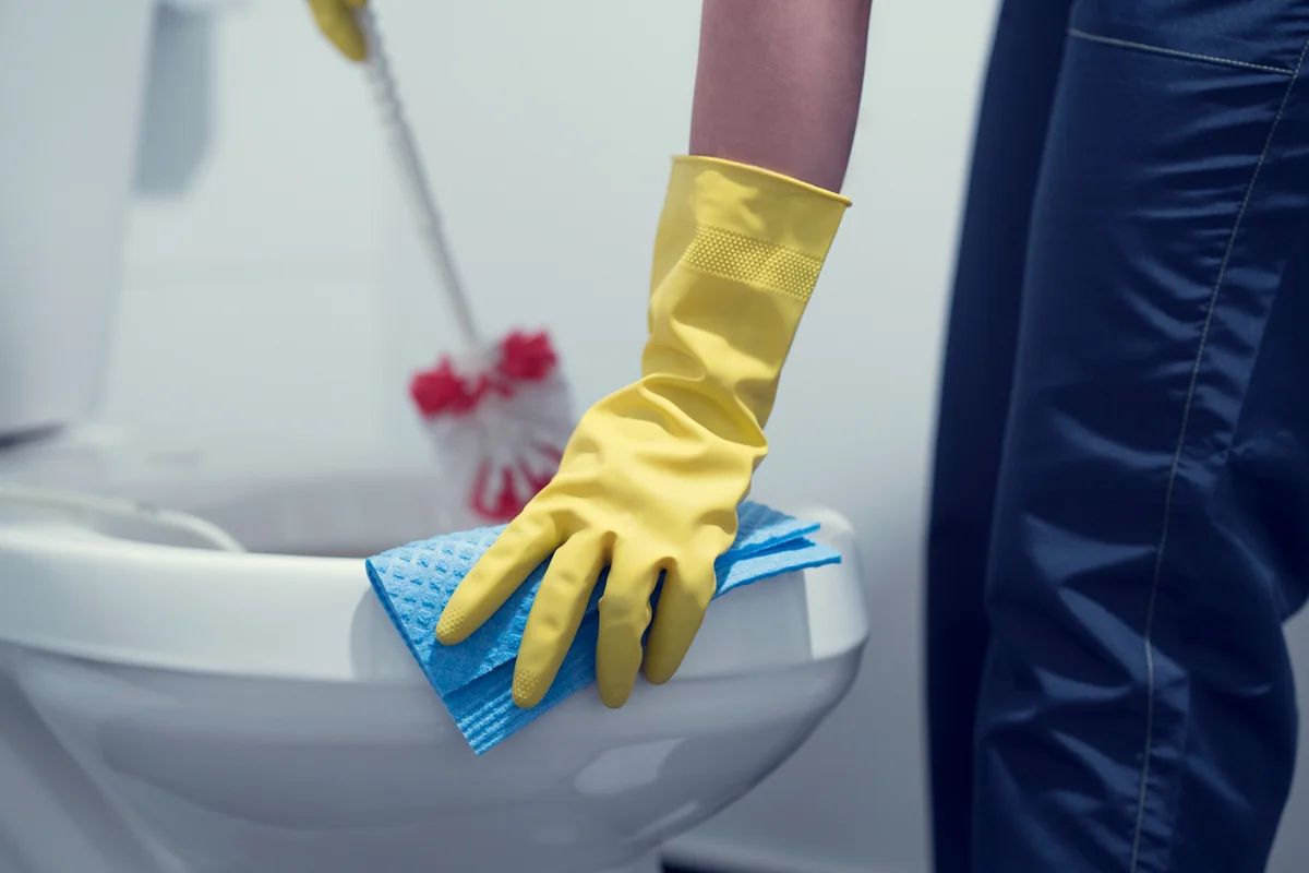 Man cleaning toilet