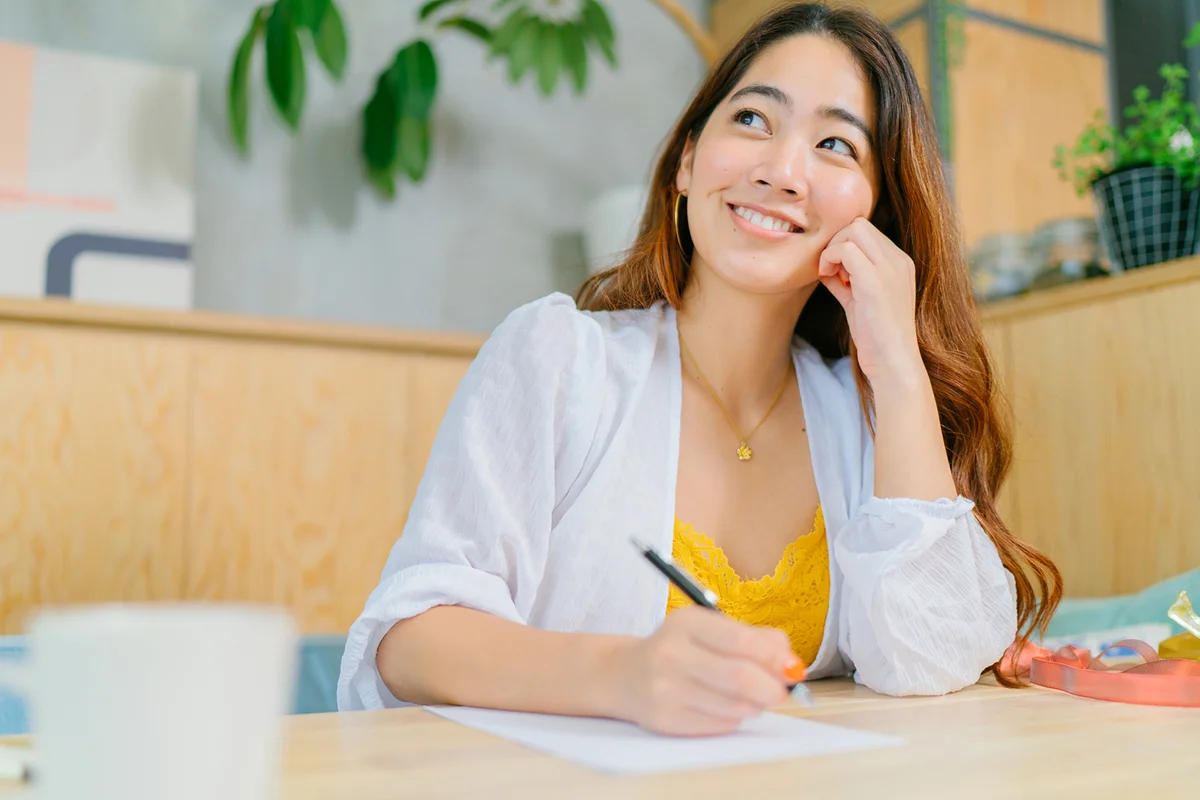 Young woman writing letter