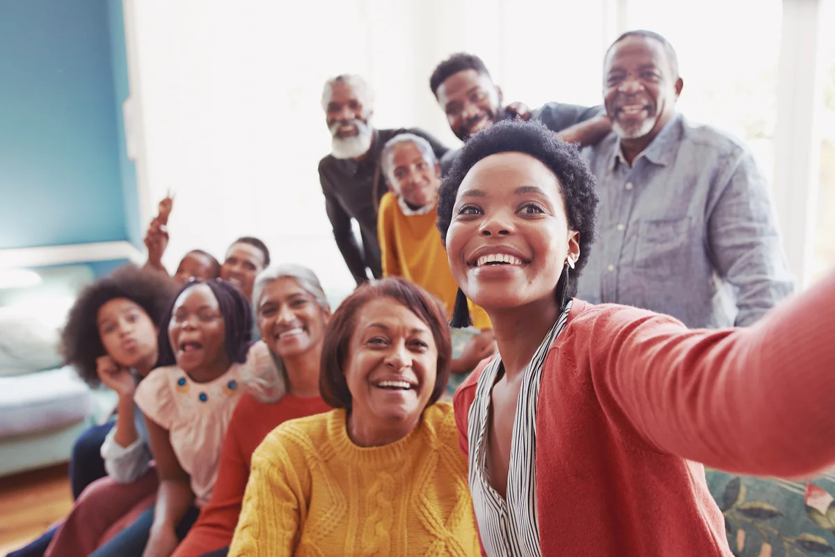 Young woman taking selfie with family