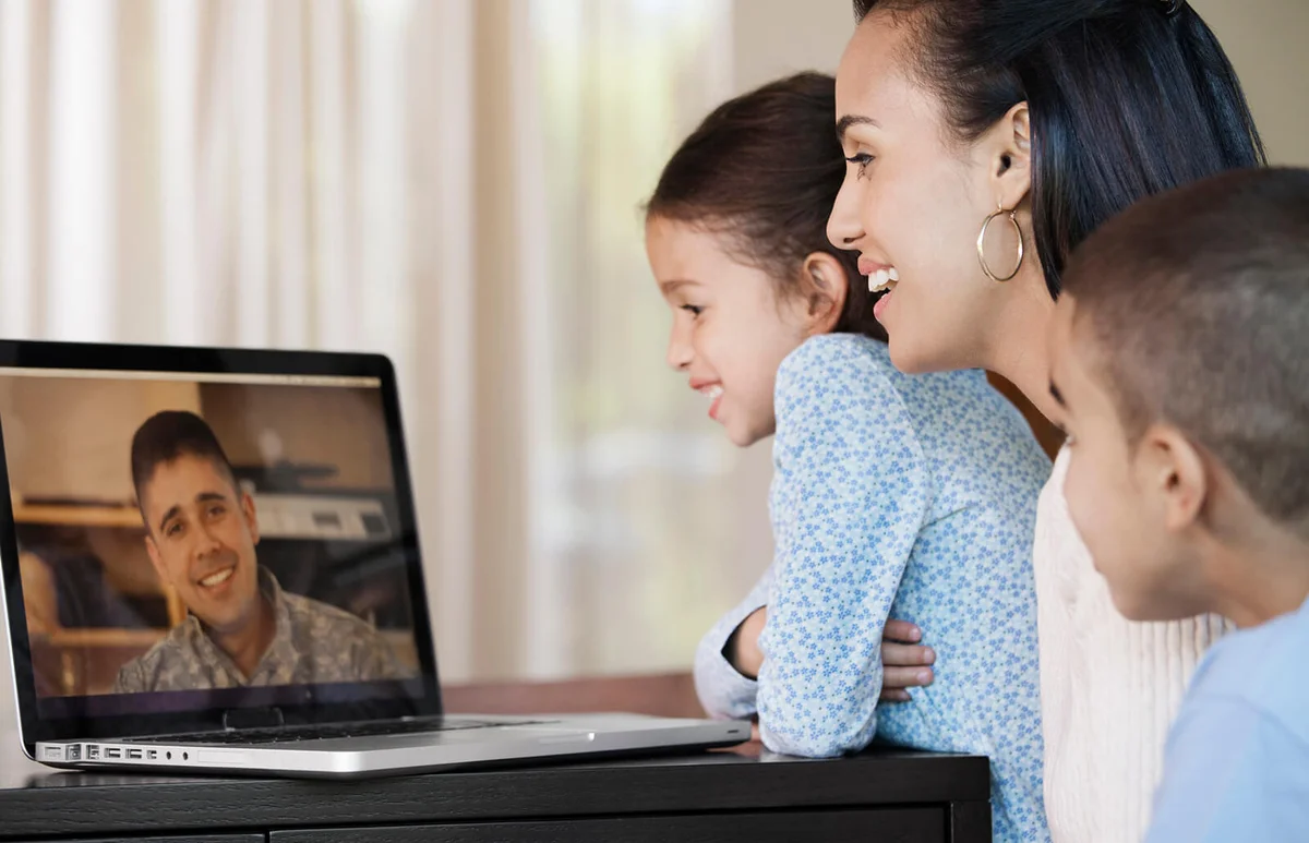 family having video chat with military father