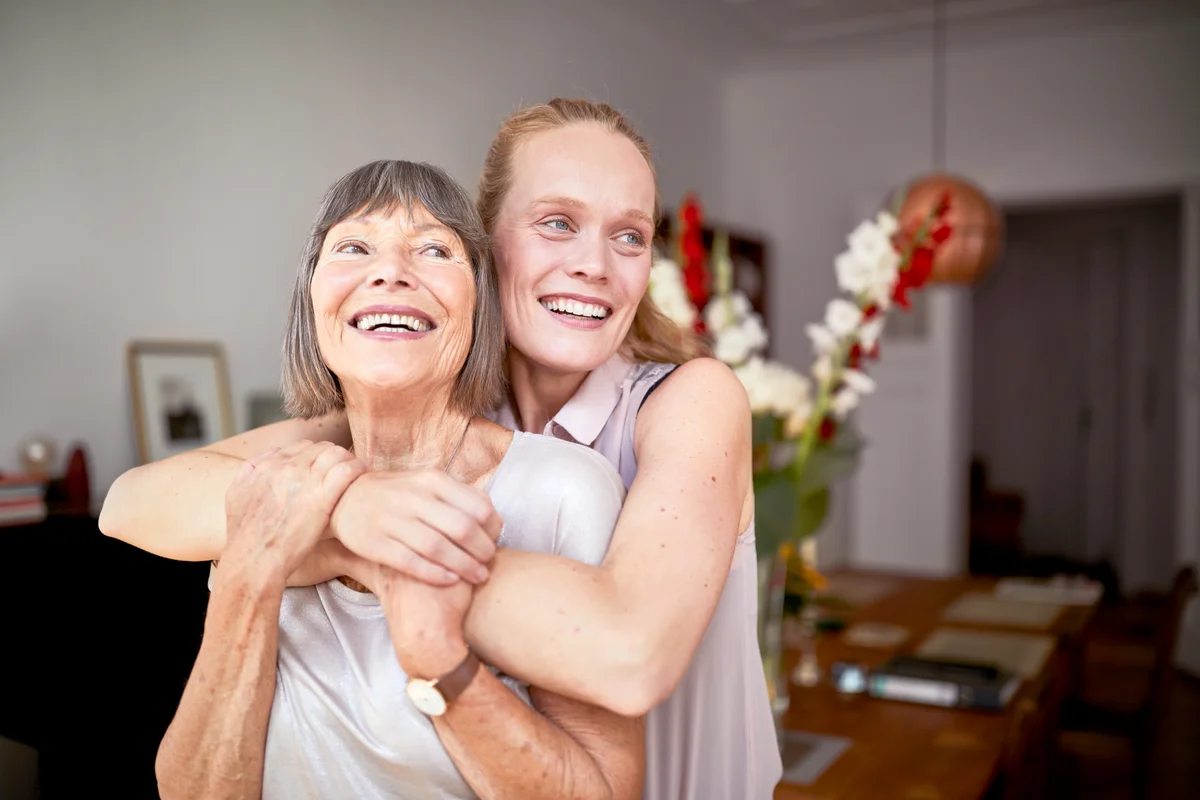 Cheerful mother and daughter at home