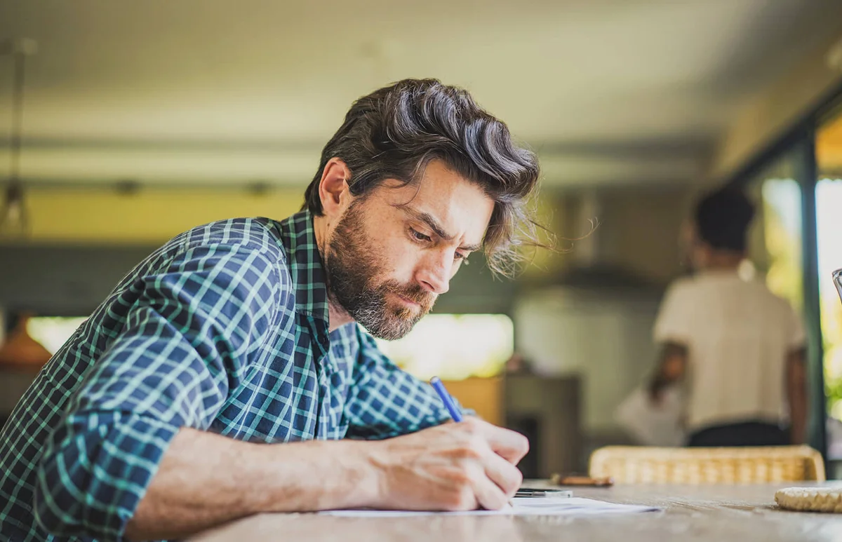 Mature man filling in paperwork