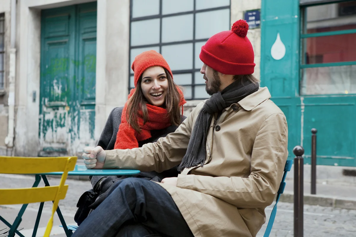 young couple sitting outside a restaurant