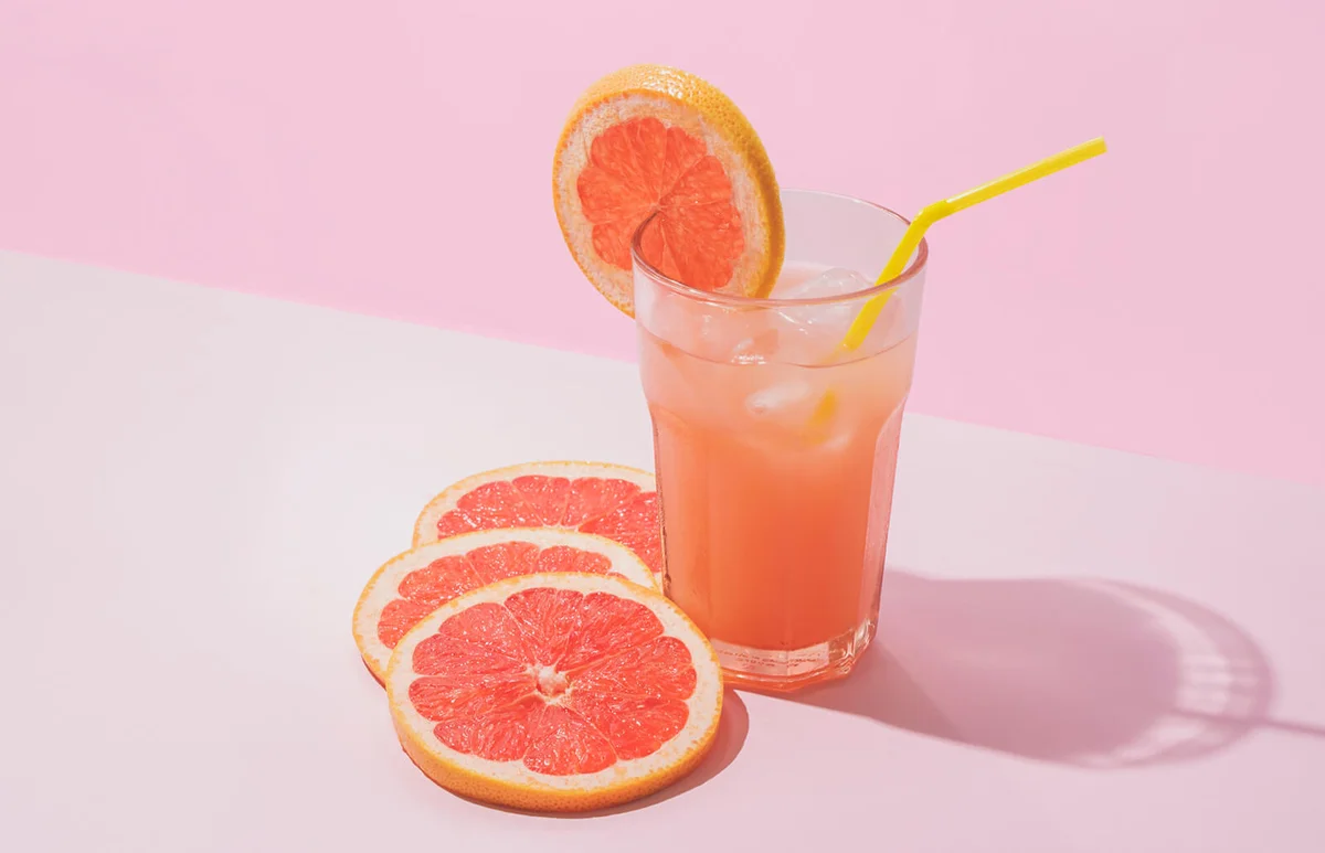 Ice Cold Homemade Grapefruit Juice On Pink Background