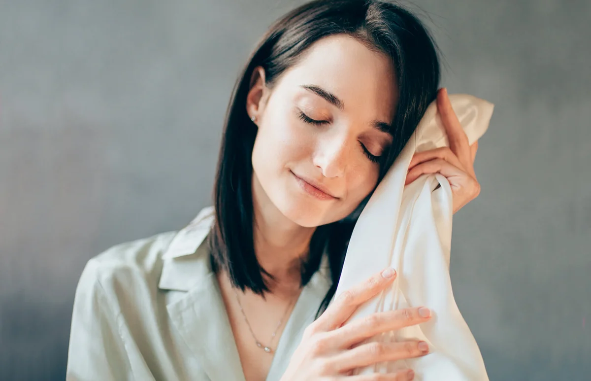 Young woman touching elegant silk