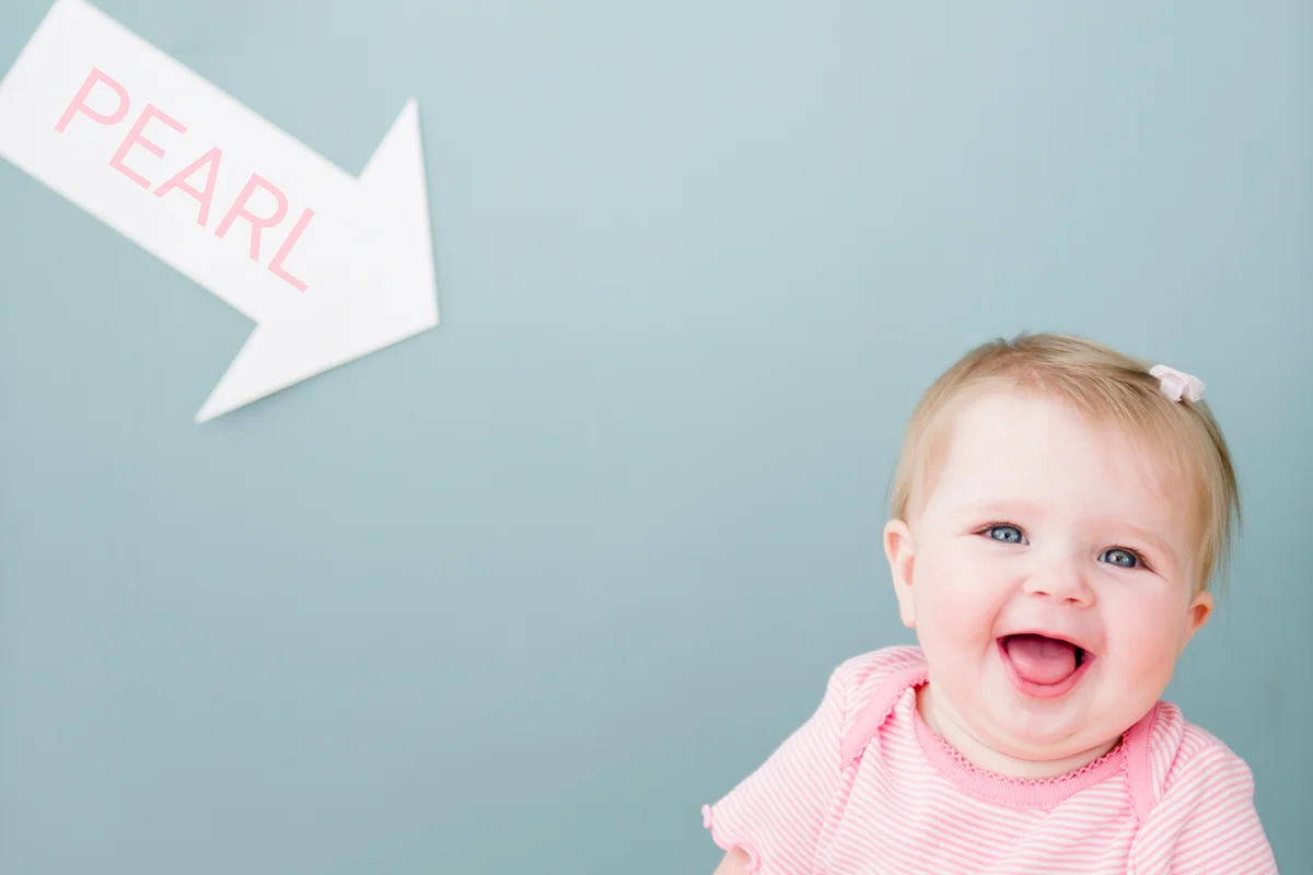 Baby girl near arrow with name Pearl