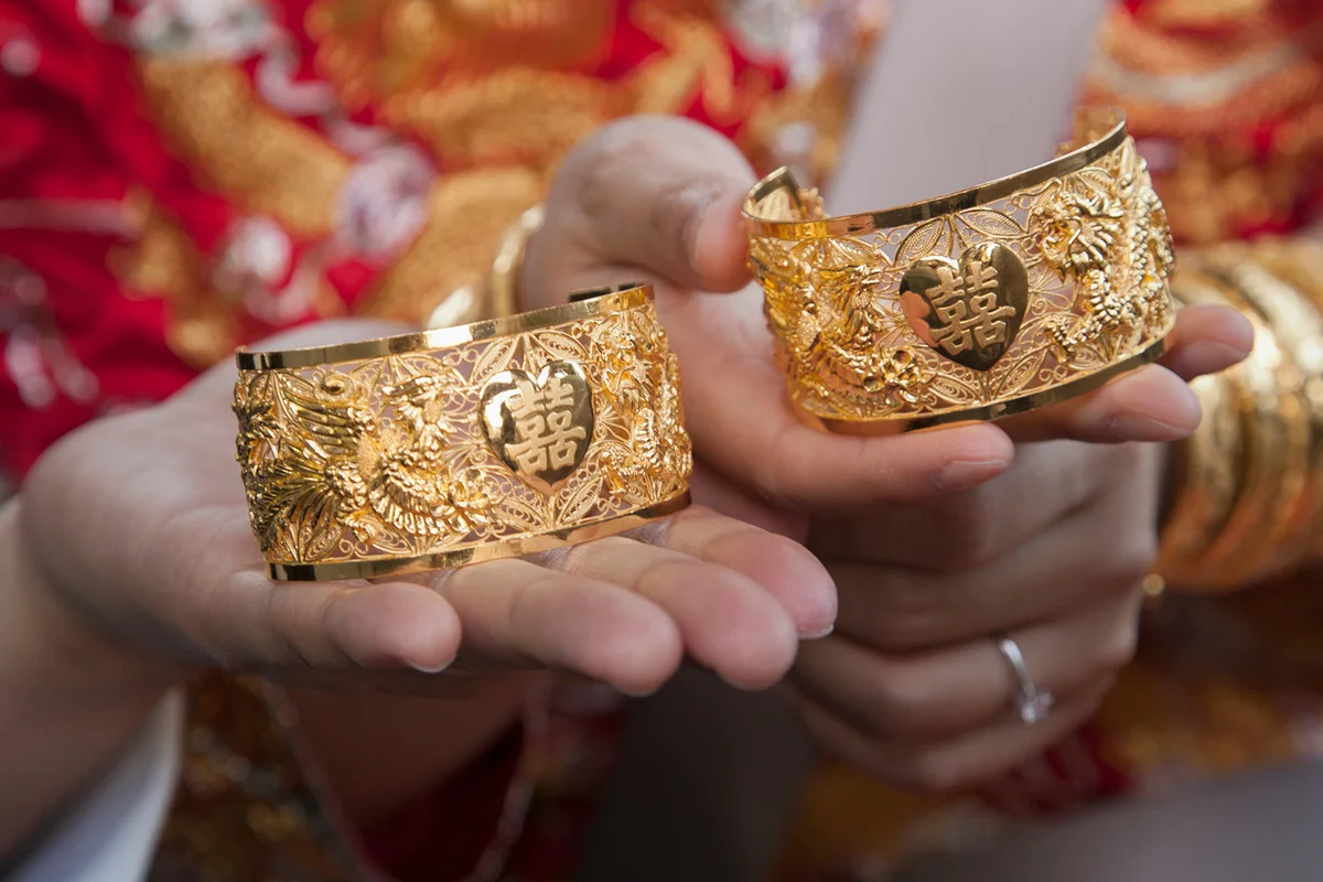 Solid gold wedding bracelets with Chinese character for happiness