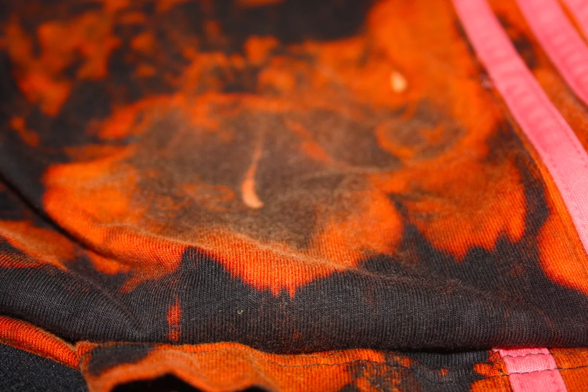 black suit fabric stained with bleach